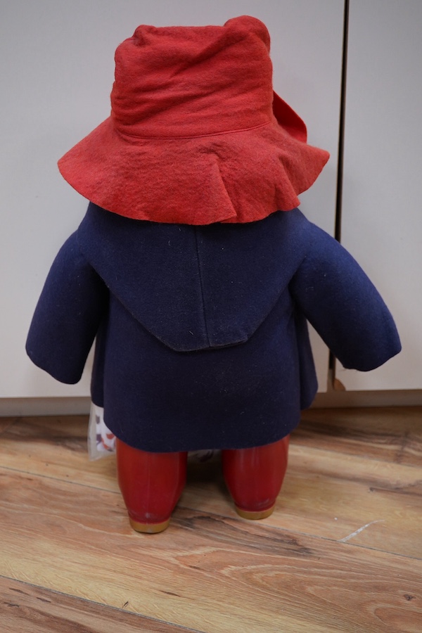 A Paddington bear with clothing and tag, 50cm high. Condition - good